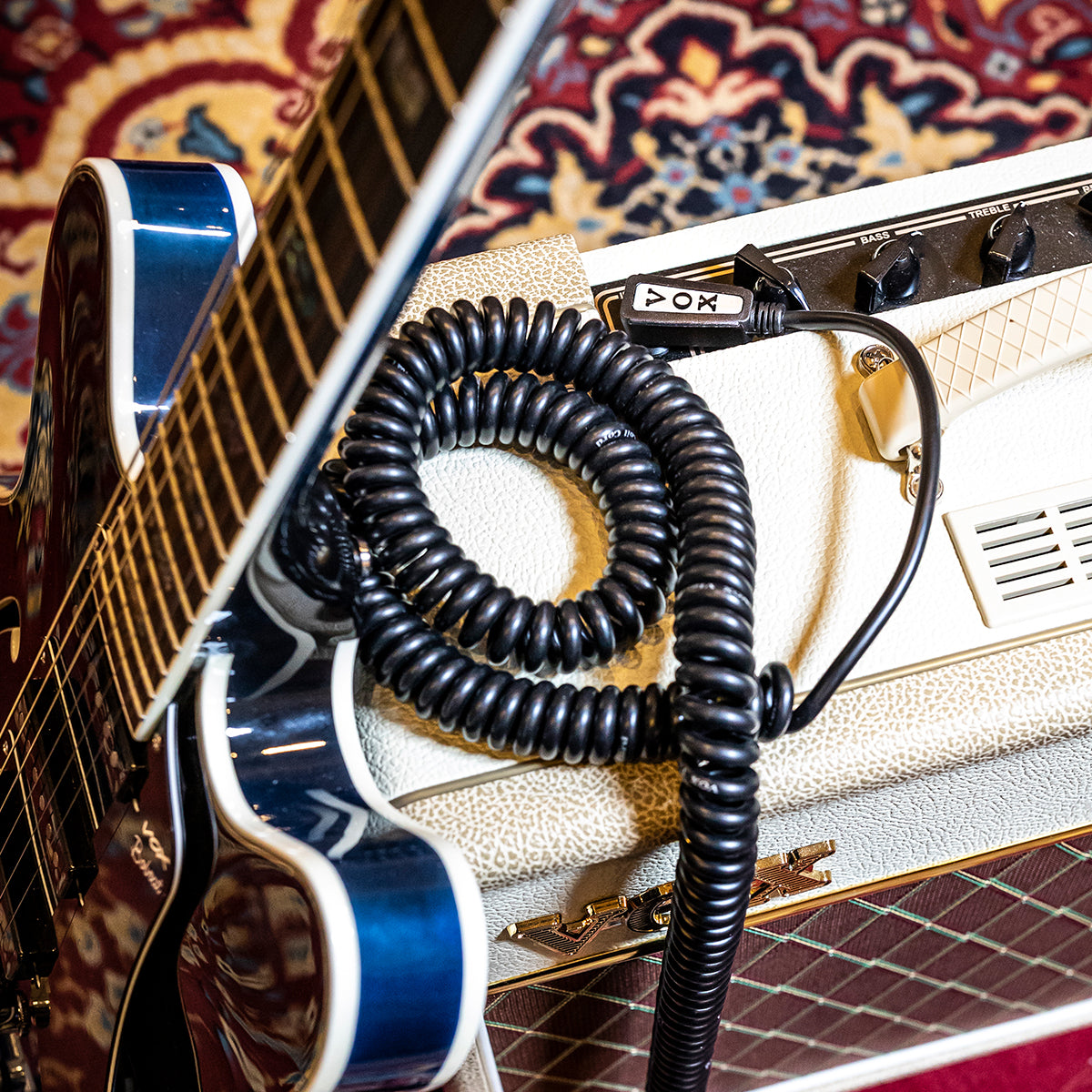 Vintage Coil Cable plugged in a VOX amplifier and blue electric guitar